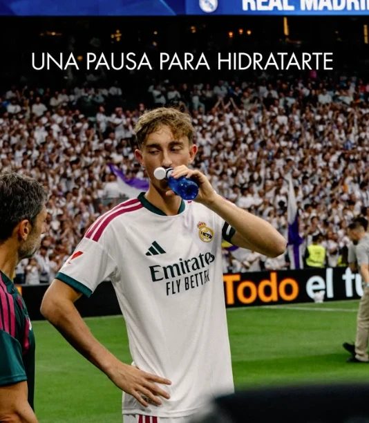Real Madrid player hydrating with Solán de Cabras pitch-side